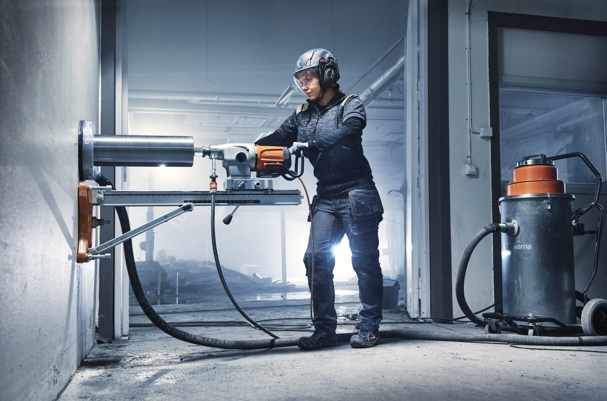 bušenje betona - na slici je osoba koja buši zid velikom bušilicom